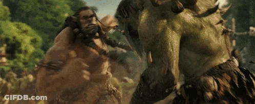 A Couple Of Giant Monsters Are Fighting Each Other In A Forest . GIF