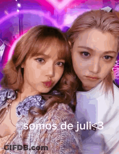 A Couple Of Girls Are Posing For A Picture With The Words Somos De Juli < 3 On The Bottom GIF