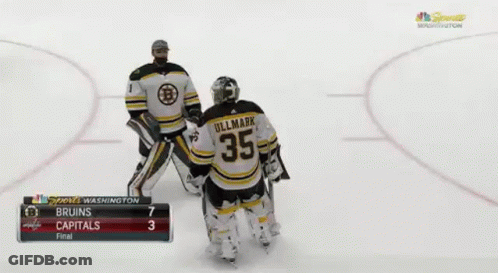 A Couple Of Hockey Players Are Standing On A Rink With Their Arms In The Air . GIF