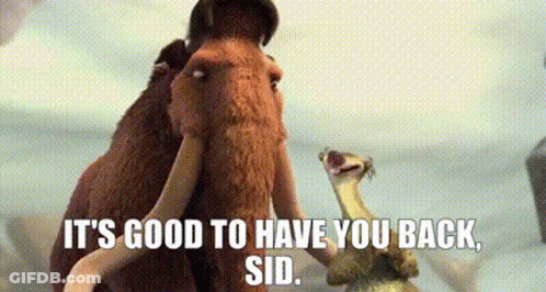A Couple Of Mammoths Standing Next To Each Other With The Words `` It 'S Good To Have You Back , Sid '' . GIF