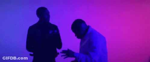 A Couple Of Men Are Dancing In Front Of A Purple And Blue Background . GIF