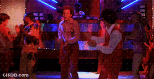 A Couple Of Men Are Dancing Together In A Disco Club . GIF