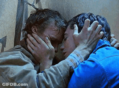 A Couple Of Men Are Hugging Each Other And One Of Them Is Covering His Face With His Hands . GIF