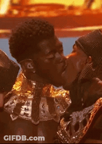 A Couple Of Men Are Kissing Each Other On The Cheek GIF