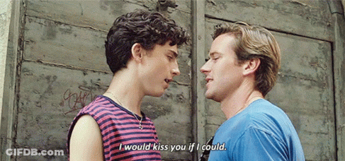 A Couple Of Men Are Standing Next To Each Other And Talking . GIF