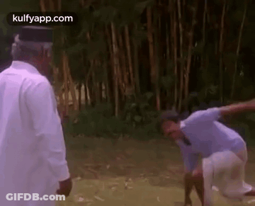 A Couple Of Men Are Standing Next To Each Other In A Field . GIF