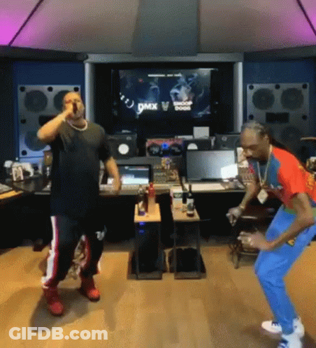 A Couple Of Men Are Standing Next To Each Other In A Room And Dancing . GIF