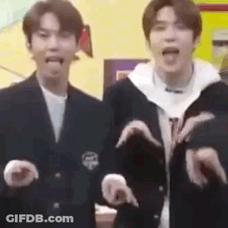 A Couple Of Men Are Standing Next To Each Other Making Funny Faces . GIF
