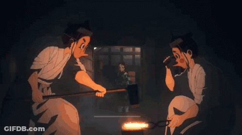 A Couple Of Men Are Working On A Piece Of Metal In A Dark Room GIF