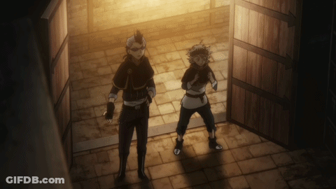 A Couple Of Men Standing In A Dark Room GIF