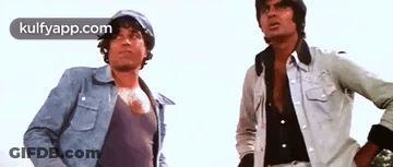 A Couple Of Men Standing Next To Each Other . GIF