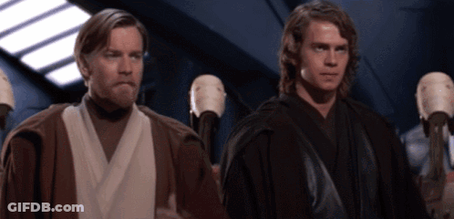 A Couple Of Men Standing Next To Each Other In A Room GIF