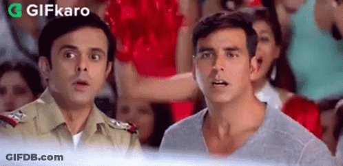 A Couple Of Men Standing Next To Each Other In Front Of A Crowd . GIF
