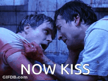 Men Standing Next To Each Other Kiss GIF