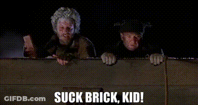 A Couple Of Men Standing Next To Each Other With The Words Suck Brick Kid Written On The Bottom . GIF