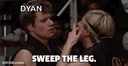 A Couple Of Men Standing Next To Each Other With The Words Sweep The Leg On The Bottom GIF