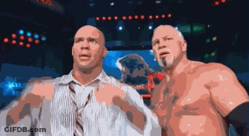A Couple Of Men Standing Next To Each Other With Their Shirts Off GIF