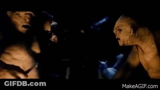 A Couple Of Monsters Standing Next To Each Other In The Dark . GIF
