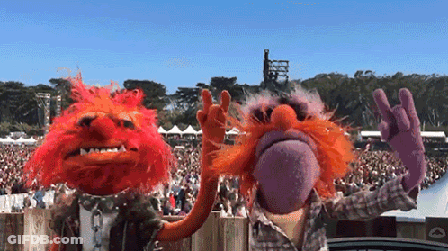 A Couple Of Muppets Standing Next To Each Other GIF