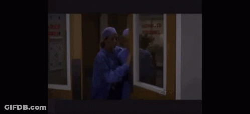A Couple Of Nurses Are Standing Next To Each Other In A Room . GIF