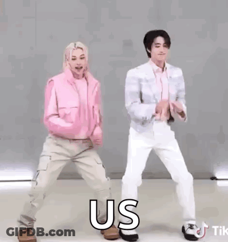 A Couple Of People Are Dancing Together And One Of Them Is Wearing A Pink Jacket And A White Shirt . GIF
