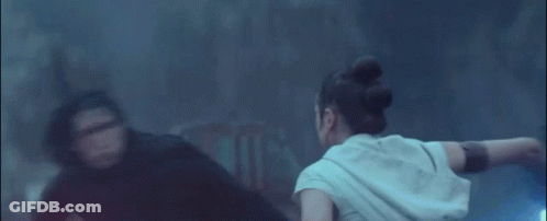 A Couple Of People Are Fighting With Lightsabers In The Dark . GIF