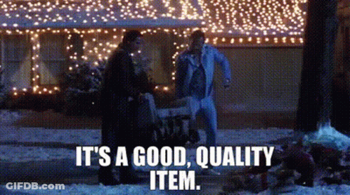 A Couple Of People Are Standing In Front Of A House With Christmas Lights On It . GIF