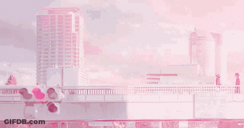 A Couple Of People Are Standing On A Bridge Over A River In Front Of A Pink Building . GIF