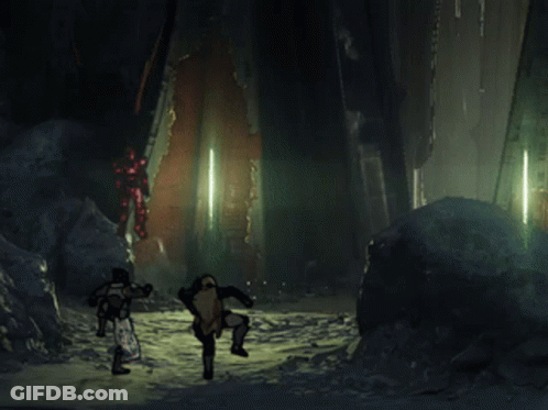 A Couple Of People Standing In A Dark Room With A Red Light Behind Them GIF