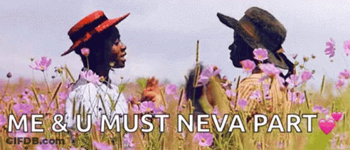 A Couple Of People Standing In A Field Of Flowers With The Words `` Me & U Must Neva Part '' . GIF