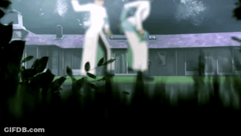 A Couple Of People Standing In Front Of A House With A Purple Roof GIF