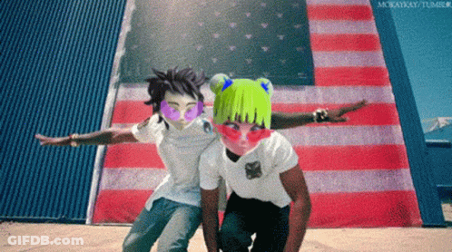 A Couple Of People Standing In Front Of An American Flag With Their Arms Outstretched GIF
