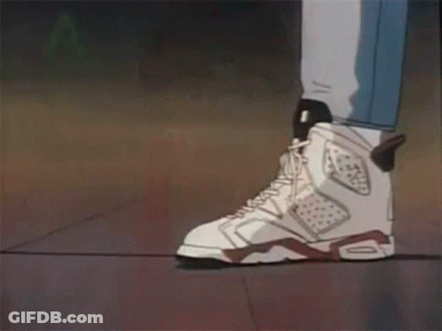 A Couple Of People Standing Next To Each Other Wearing White Sneakers . GIF