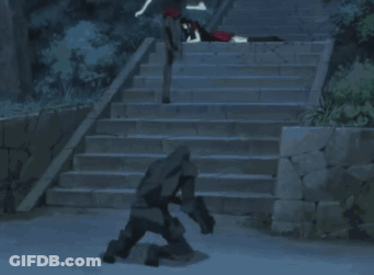 A Couple Of People Standing On A Set Of Stairs With A White Car In The Foreground GIF