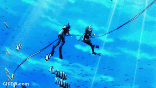 A Couple Of Scuba Divers Are Swimming In The Ocean With Fish GIF