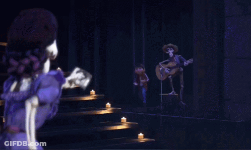 A Couple Of Skeletons Standing Next To Each Other With One Wearing A White Sombrero GIF