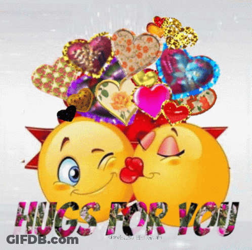 A Couple Of Smiley Faces Kissing With The Words Hugs For You GIF