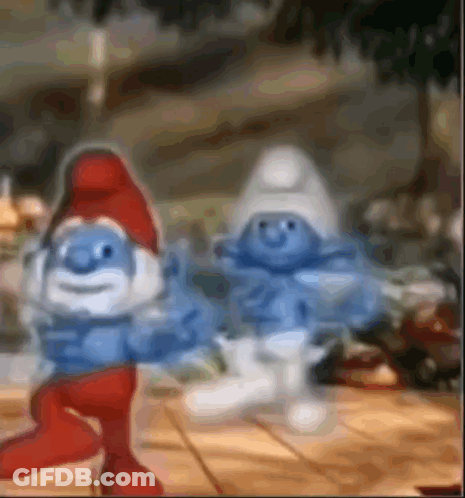 A Couple Of Smurfs Standing Next To Each Other On A Table . GIF