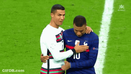A Couple Of Soccer Players Are Hugging Each Other On A Field . GIF