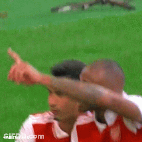 A Couple Of Soccer Players Are Standing On A Field And One Of Them Is Pointing At The Camera . GIF