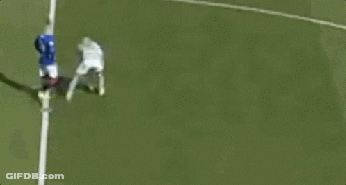 A Couple Of Soccer Players Are Standing On A Field Talking To Each Other . GIF