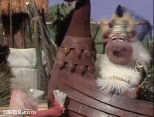 A Couple Of Stuffed Animals Standing Next To Each Other With One Wearing A Crown GIF