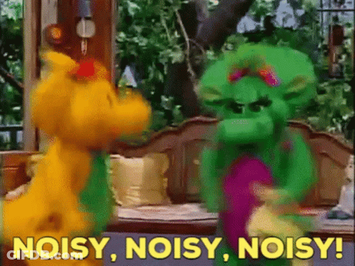 A Couple Of Stuffed Animals Standing Next To Each Other With The Words Noisy Noisy Noisy In The Background GIF