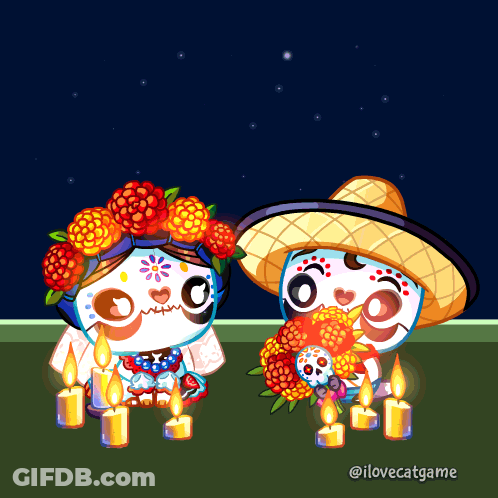 A Couple Of Sugar Skulls Sitting Next To Each Other GIF