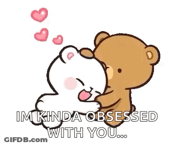 A Couple Of Teddy Bears Are Sitting Next To Each Other . GIF