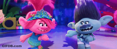 A Couple Of Trolls Standing Next To Each Other On A Dance Floor . GIF