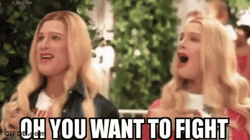 A Couple Of Women Are Standing Next To Each Other And One Of Them Is Screaming . GIF