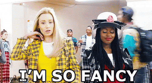 A Couple Of Women Are Standing Next To Each Other In A Hallway . GIF