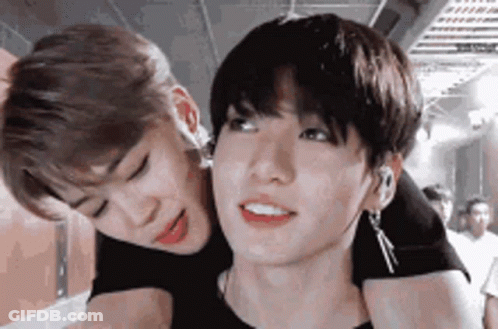 A Couple Of Young Men Are Standing Next To Each Other . GIF