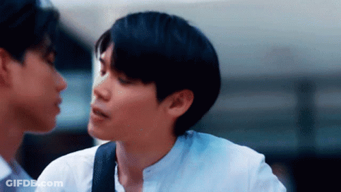 Two Young Men Standing Next To Each Other GIF